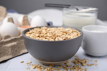 Different ingredients for cooking tasty oatmeal pancakes on white table, closeup