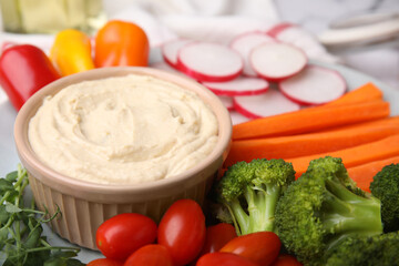 Plate with delicious hummus and fresh vegetables, closeup