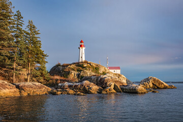 View of a Lighthouse on a rocky coast during a cloudy day, historic landmark Point Atkinson...