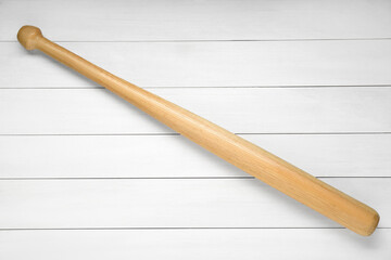 Baseball bat on white wooden table, top view. Sports equipment