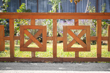 Beautiful wooden fence near green lawn on sunny day outdoors