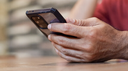 Cropped view of hand shot of man holding smartphone