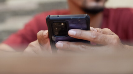 Cropped view of hand shot of man holding smartphone