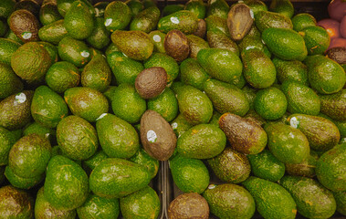 Mississauga, Ontario, Canada - May 27 2017: In a supermarket, lots of green avocados close up.
