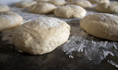 Fototapeta na wymiar Balls of pizza dough in a kitchen