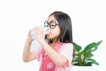 child asia girl  drink milk with a glass