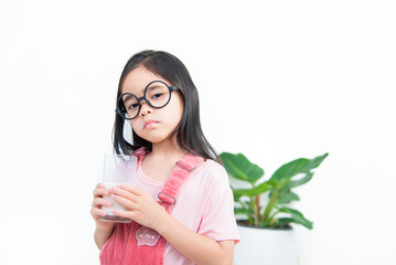 child asia girl  drink milk with a glass