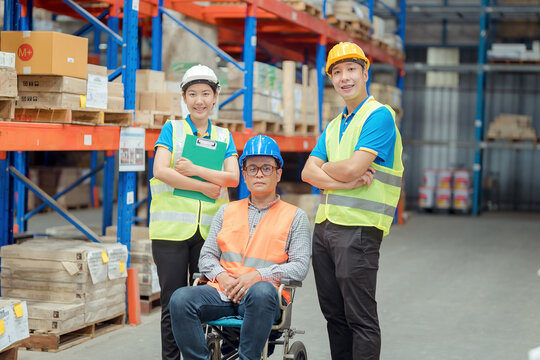 The supervisor is handicapped with a wheelchair inspecting the work background in warehouse.logistic  business export ,Warehouse worker checking packages on store