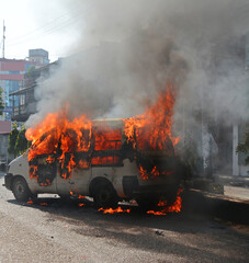 Burning car Fire suddenly started engulfing all the car. Car on fire accident, out of focus with grain.