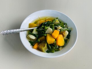 clear vegetable made from a combination of long beans, eggplant, pumpkin, bamboo shoots, and long bean leaves. very delicious served on a rainy