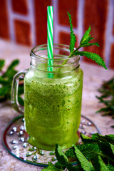 green fruit lemonade. green fruit juice. refreshing kiwi drink. tropical fruits. cold drink in large glass. 