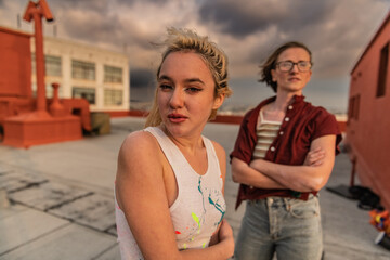 A non-conforming couple enjoys golden hour on a chilly DTLA rooftop