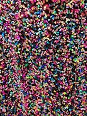 Colorful shiny sequin fabric texture, pink, yellow, blue, fun fashion bg background