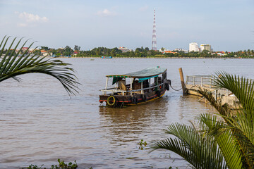 Ho Chi Minh City, Vietnam- November 9, 2022: Tourist boat at the river bank of the Mekong river at...