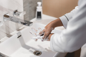 Close up of people washing hand with liquid soap carefully.