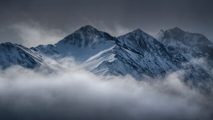 Caucasian mountains in the clouds. View from Kamunta village. Mountain Digoria, North Ossetia.