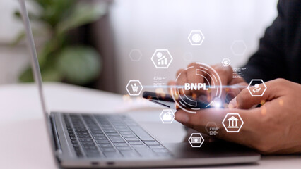 Businessmen holding a smartphone with icons of BNPL with online shopping icons technology. BNPL Buy...