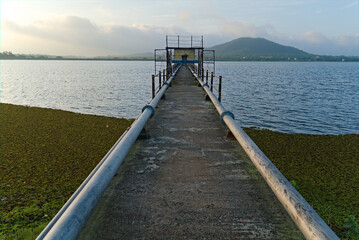 Fototapeta premium 14.07.2021. purulia, west bengal, india. pump house leading to th middle of lake with pipeline in purulia, india