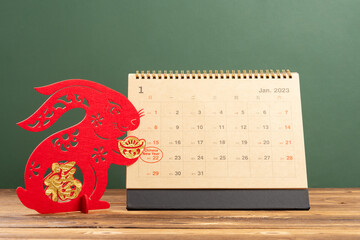 Chinese New Year of Rabbit mascot with 2023 calendar with the New Year day highlighted translation...