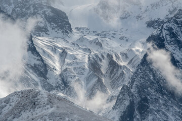 Caucasian landscape. Lower part of West Kaysar glacier on sunny winter day. Mountain Digoria, North Ossetia, Russia.