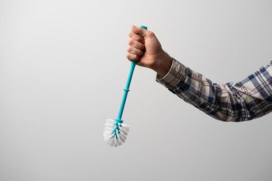 hand holds toilet or bath brush, hygiene care at home