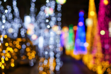 Blurred and bokeh of Christmas holiday lighting on night time background.