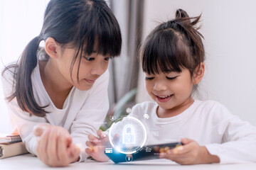 Child safety online. Little girl using smartphone at home. icon of internet blocking app on...