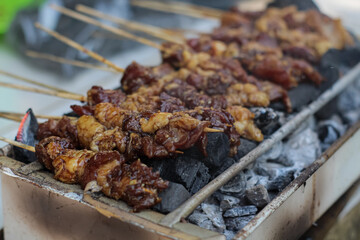 Satay beef is beef skewered by small bamboo and grilled with spices and served with peanut sauce.