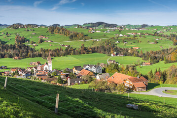 Fototapeta na wymiar Typical hilly landscape in the Appenzellerland with villages, green meadows and pastures. Haslen, Canton Appenzell Innerrhoden, Switzerland