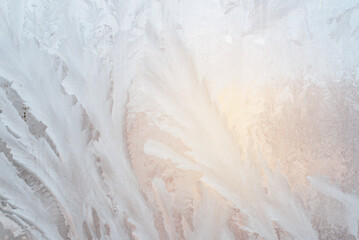 Abstract ice pattern on window glass. Hoarfrost texture background on sunny winter day
