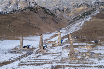 Aerial view of medieval Ingush towers complex Niy on sunny winter day. Ingushetia, Caucasus, Russia.