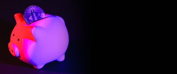 Piggy bank on a dark background with Bitcoin and purple pink backlight. Banking concept. Bitcoin mining concept. Banner