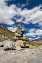 Apacheta Andean tradition, stone on stone with background of the Peruvian highlands