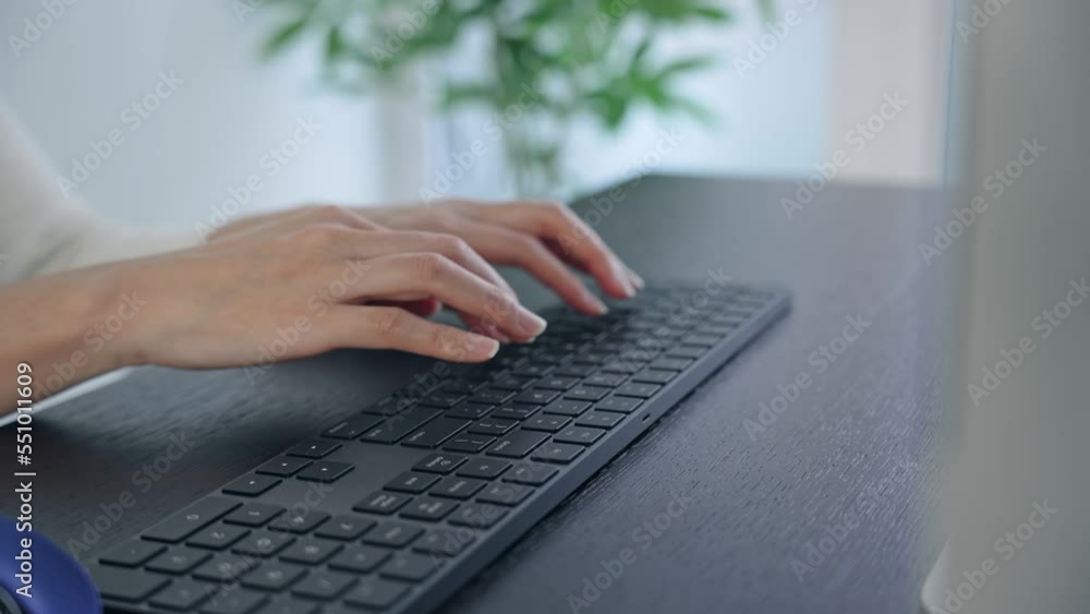 Poster close-up of a woman's hand using a desktop computer in the office.