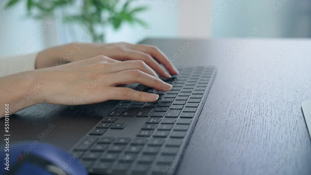 Poster close-up of a woman's hand using a desktop computer in the office.
