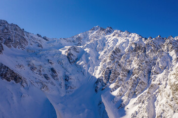 Fototapeta na wymiar Mount Aday-Khoh (4408 m) on sunny winter day. Tsey, North Ossetia, Russia.