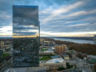 Aerial view of modern buildings on a bank of a river in Fort Lee, New Jersey at sunset