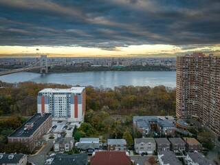 Aerial view of modern buildings on a bank of a river in Fort Lee, New Jersey at sunset