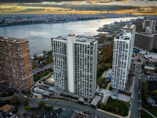Aerial view of modern buildings on a bank of a river in Fort Lee, New Jersey at sunset