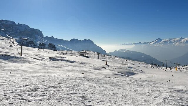 Madonna di Campiglio. Amazing aerial view at the ski slopes from the gondola lift reaching the top of the mountain. Italian Dolomites. Best of ski resort