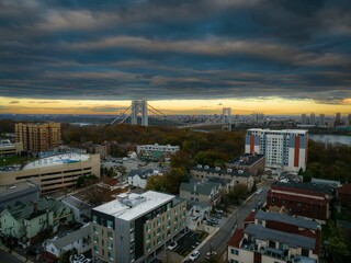 Aerial view of modern buildings and streets in Fort Lee, New Jersey at cloudy sunset