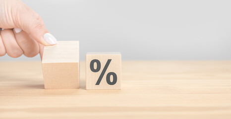 percentage change. interest rate change one with space for text, one cube with percent sign. wooden cubes with percent symbol. Business concept, copy space.