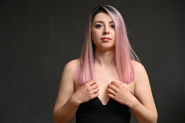 Caucasian girl with dyed hair shows sensual emotions to the camera - 551017409