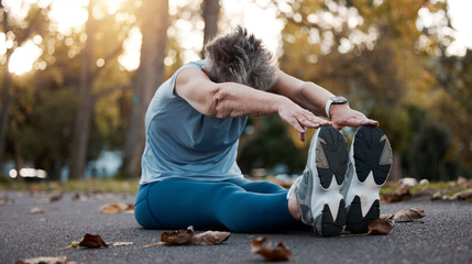 Senior woman, stretching and exercise on asphalt road for fitness, workout and touching feet with...