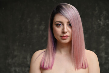 Model with dyed hair looking directly at the camera