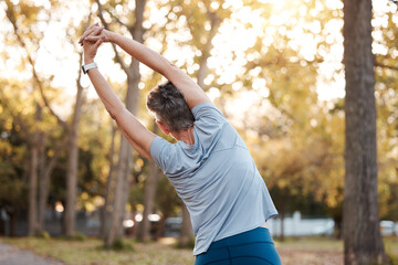 Fitness, park and stretching with a senior woman doing a warm up outdoor for exercise or a workout. Nature, health and training with a mature female back outside in a garden for a healthy lifestyle