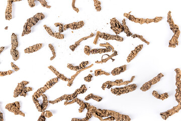 Valerian roots scattered background close up isolated over white top down