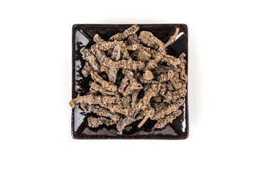 Valerian roots in a black ceramic tray top down view