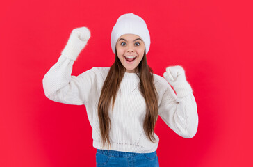 surprised teen girl in warm winter knitwear sweater and mittens in studio. teen winter girl