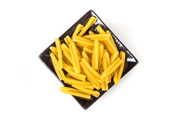 Gluten free corn rice quinoa pasta in a ceramic tray over white background top down